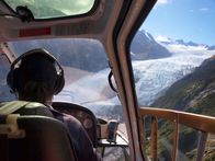 Die Modellbauer – Helicopter pilot seen from behind above a glacier