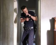 The Rookie – Officer John Nolan (Nathan Fillion) durchsucht akribisch ein leerstehendes Haus nach Verdächtigen.