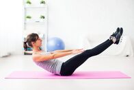 Doc Fischer – Woman doing abdominal exercise on mat at home stretching pilates yoga fitness, sport, training.