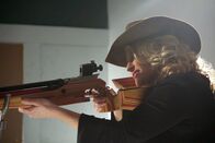 Mysterien des Weltalls – University of Michigan Professor of Physics Katie Freese poses with a pellet gun at a shooting range to show how a DNA detector works to hunt for dark matter.