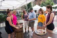 Flea Market Flip - Die Schnäppchenjäger – Sell day at Grand Bazaar Flea Market and contestants Jennifer (L) and Stephanie (M) show a family of potential buyers (R) their rustic reimagined shelving unit.