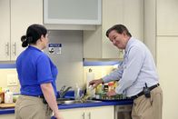 Superstore – -- "Spokesman Scandal" Episode 205 -- Pictured: (l-r) Lauren Ash as Dina, Mark McKinney as Glenn -- (Photo by: Evans Vestal Ward/NBC)