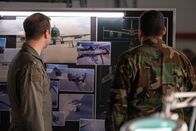 Mayday - Alarm im Cockpit – REENACTMENT - Lt. Colonel Ike Stokes (played by Mathieu Bourassa) and another Investigator examine photographs and blueprints of a US Air Force KC-135 to determine why it lost two engines mid-flight during Operation Desert Storm. (Cineflix 2020/Darren Goldstein)