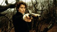 Sleepy Hollow - Köpfe werden rollen – Ichabod Crane (Johnny Depp) nimmt inmitten eines Waldstücks eine mysteriöse Gestalt auf einem weißen Pferd wahr, auf die er seine Waffe richtet.