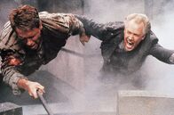 Total Recall – Quaid/Hauser (Arnold Schwarzenegger, l.), Cohaagen (Ronny Cox, r.)