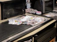 Couponing Extrem – Cashier with a stack of coupons