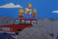 Die Simpsons – Lisa, Homer (Mi.) und Bart freuen sich, dass die Rhinozerosse erledigt sind.