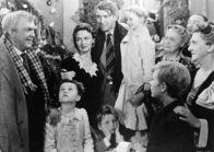 Ist das Leben nicht schön? – Uncle Billy (Thomas Mitchell, l.), Janie (Carol Coombs, 2.v.l.), Mary Hatch (Donna Reed, 3.v.l.), Tommy (Jimmy Hawkins, unten, 4.v.l.), George Bailey (James Stewart, 5.v.l.), Zuzu (Karolyn Grimes, 5.v.r.), Pete (Larry Simms, 4.v.r.), Mrs. Bailey (Beulah Bondi, r.)