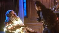 Violent Night – l-r: Santa (David Harbour), Scrooge (John Leguizamo)