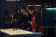 Mayday - Alarm im Cockpit – A Nepalese investigator (played by Leon Aureus) and Andrew Robinson (played by Philip Graeme) inspect a topographical map to help determine the cause of Pakistan International Airlines Flight 268's tragic accident. (Cineflix 2018/Darren Goldstein)