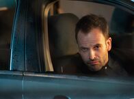 Elementary – Holmes (Jonny Lee Miller) muss die Wahrheit akzeptieren, dass Irene selbst Moriarty ist und ihn damals in London nur kennenlernen wollte, um zu sehen, wie gefährlich er ihr werden könnte ...