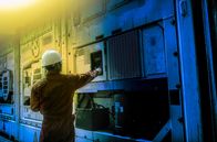 Helden des Handwerks – worker checking air container in night time.