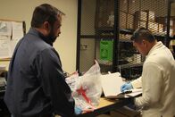 Schmugglern auf der Spur – HSI Agent Steve Ledgerwood and Mario Cebrera place the gun and drugs that were seized in the evidence room. (National Geographic/Lucky 8 TV)