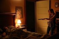 Evil – Cindy aiming a shotgun at sleeping Bob.