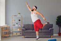 111 – Funny red fat man doing exercises while standing at home