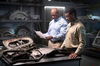Mayday - Alarm im Cockpit – The Lead Namibian Investigator (played by Jamaal Grant) and Investigator Dennis Jones (played by Glen Michael Grant) review important documentation ahead of analyzing pieces of wreckage from LAM Mozambique Flight 470.(Cineflix/Pana Pantazidis)