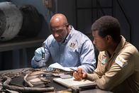 Mayday - Alarm im Cockpit – The Lead Namibian Investigator (played by Jamaal Grant) and Investigator Dennis Jones (played by Glen Michael Grant) take a closer look at pieces of wreckage from LAM Mozambique Flight 470. (Cineflix/Pana Pantazidis)