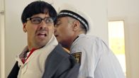 All In – Jamu (Daniel Popat) wird von einem Polizisten (Züli Aladağ) festgenommen.