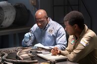 Mayday - Alarm im Cockpit – The Lead Namibian Investigator (played by Jamaal Grant) and Investigator Dennis Jones (played by Glen Michael Grant) take a closer look at pieces of wreckage from LAM Mozambique Flight 470. (Cineflix/Pana Pantazidis)