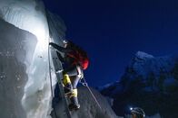 Expedition Everest – Climbing guide Dawa Yangzum Sherpa ascends a ladder while traversing the route to Everest's summit as part of the National Geographic and Rolex Perpetual Planet Everest Expedition. (National Geographic Society/Mark Fisher)