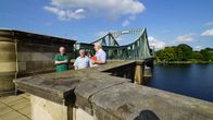 Geheime Fronten – Erinnerung an einen Agentenaustausch: Nigel Dunkley, Lawrence G. Kelley und Jean-Paul Staub an der Glienicker Brücke, Berlin-Potsdam.