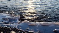 Russlands weite Wildnis – Lake Baikal, Russia - Waters of Lake Baikal lapping at its frozen edge.