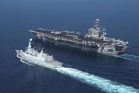 Warship – British Royal Navy destroyer HMS Diamond (D34) transits alongside aircraft carrier USS Dwight D. Eisenhower (CVN 69).