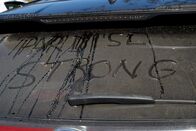 Rebuilding Paradise – Paradise, CA - A rear window of a vehicle with the words "Paradise Strong" written in the dirt. (National Geographic/Sarah Soquel Morhaim)