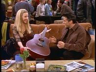 Friends – Joey (Matt LeBlanc, r.) will Gitarre spielen lernen, aber ob Phoebe (Lisa Kudrow, l.) eine gute Lehrerin ist ...