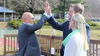 Hotel Impossible – Host Anthony Melchiorri high-fives owner Shaun Lyons on the pool patio of Water Gap Country Club while Julie Lyons looks on, as seen on Travel Channel's Hotel Impossible.