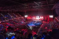 WWE Rivals – Blurry boxing stadium for background.