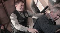 Skin Collector – L-R: Detective Delgado (Casper Van Dien), Franklin Rood (John Jarratt)