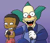 Die Simpsons – Beim Gesangswettbewerb: Lisa (l.) und Krusty (r.) ...