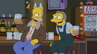 Die Simpsons – Während Marge und die Kinder am Heiligabend auf das Familienoberhaupt warten, feiert Homer (l.) mit Moe (r.) ...