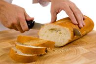 Marktcheck – slicing bread on wood cutting board with a bread knife