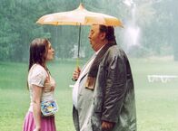Bloch – Regen hin oder her, Laura (Julia Jentsch) hat Bloch (Dieter Pfaff) dazu gebracht, mitten im Park mit ihr Kanons zu singen.