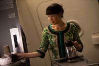 Mayday - Alarm im Cockpit – Subject: REENACTMENT - A Malaysia Airlines flight attendant (played by a background performer) goes about her regular duties on Flight 370.(photo credit: Cineflix/Darren Goldstein)