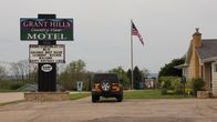 Hotel Impossible – The sign for the Grant Hills Motel looms above the sign for Blaum Bros. Distilling Co. in Galena, Illinois.