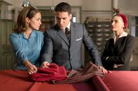 Velvet – Ana und Isabel zeigen Alberto die Stoffe für die Airsa-Uniformen (von li nach re: Paula Echevarría, Miguel Ángel Silvestre, Angela Molina).