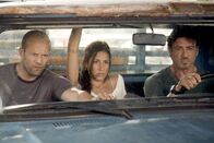 The Expendables – Lee Christmas (Jason Statham, links), Sandra (Giselle Itié) und Barney Ross (Sylvester Stallone) haben Probleme.