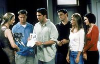 Friends – Nur zusammen finden Chandler (Matthew Perry, 2.v.l.), Ross (David Schwimmer, 3.v.l.), Joey (Matt LeBlanc, 3.v.r.), Rachel (Jennifer Aniston, 2.v.r.) und Monica (Courteney Cox, r.) den Mut, Phoebe (Lisa Kudrow, l.) zu sagen, dass die Katze, die sie gefunden hat und in der sie die Reinkarnation ihrer toten Mutter sieht, bereits jemandem gehört.