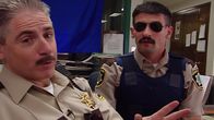 Reno 911! – L-R: Deputy James Garcia (Carlos Alazraqui), Deputy Travis Junior (Robert Ben Garant)