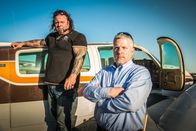 Airplane Repo - Die Inkasso-Piloten – Ken Cage and Danny Thompson standing in front of a car outside.
