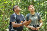 GEO Reportage – Amir Finches (li.) und Umweltaktivist Shane Chiok (re.) beobachten wilde Singvögel auf der Insel Pulau Ubin vor Singapur.