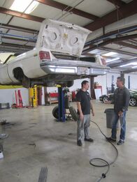 Fast N' Loud – Richard Rawlings and Tom Smith talk next to the elevated 1975 Olds Delta 88.