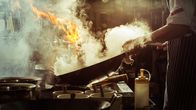 Restaurant Impossible – Chef is stirring vegetables in wok, vintage filter