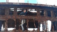 Man vs. Wild – Bear looking through hole in the rusty shipwreck.