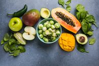 Doc Fischer – Foods high in folic acid. Vegetables, fruits rich in vitamin C on a blue background. Top view, flat lay, copy space