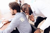 111 – The men stuck a sticker on the back of another man. This is his business colleagues.