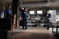 Castle – Captain Frank Mahoney (Allan Louis, l.) teilt Beckett (Stana Katic, r.) mit, dass sie sich auf keinen Fall bewegen darf, weil sie auf einem versteckten Auslöser einer Bombe steht. Castle (Nathan Fillion, M.) verspricht, ihr zur Seite zu stehen ...
